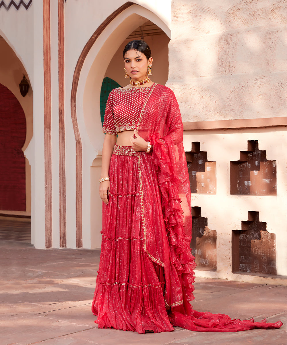 Red embroidered shimmer 
layered lehanga set